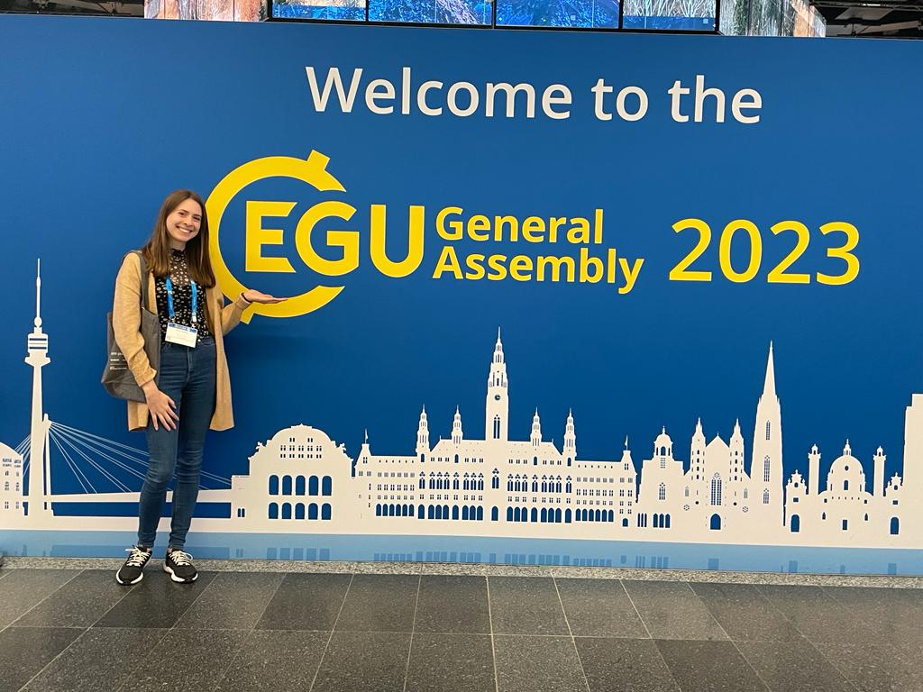 Amy Shipley in front of the EGU 2023 sign in Vienna